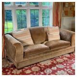 BROWN VELVET COUCH | Light brown velvet sleeper sofa with curved arms and red trim upholstery, accom