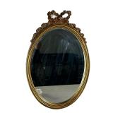 OVAL MIRROR IN GILT FRAME | Oval mirror with ribbon and bow carving on top in gilt frame. - w. 15 x 