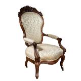 Gentlemen’s Chair | Carved walnut chair with floral crowning on top and floral cream cushioning. - l