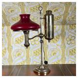 Student Oil Lamp | 19th-century student oil lamp, electrified, with red glass lampshade. The mechani