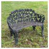 Wrought Iron Bench | Small wrought iron garden bench painted black with grapevine motifs composing t
