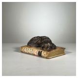 Dog On A Book | Desk ornament of a hunting dog curled up and sleeping on a vintage book. - l. 7 x w.