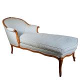 CARVED WOOD LOUNGER | Blue and white gingham cushions with curved back and scrollwork carving in arm