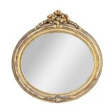 ROUND GILT MIRROR | Oval-shaped mirror with floral relief on bottom and carved ribbon bow on top. - 