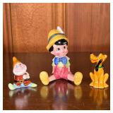 DISNEY CERAMIC FIGURINES | Includes: Pinocchio, Happy (from Snow White), and Pluto the dog. - l. 3.2
