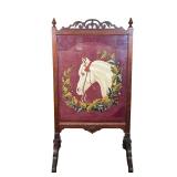 HORSE NEEDLEPOINT IN ANTIQUE FRAME | Carved antique frame with scroll work on top framing horse need