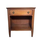 MID CENTURY WOODEN BEDSIDE TABLE | Carved wood side table with drawer, round brass pulls, and shelf 