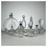 Clear Glass Perfume Bottles | Assorted clear glass perfume bottles. Some cut glass, some with sterli