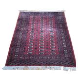 BURGUNDY BOKHARA RUG | Burgundy rug with three rows of guls. 