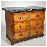 MINIATURE CHEST WITH MARBLE TOP | Chest with three inlaid drawers on bun feet. Brass pulls & escutch