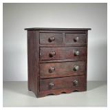 MINIATURE DOVETAILED CHEST | Chest in old dark finish, crackled and worn. Two drawers over four with