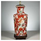 Vibrant Chinese Lamp | Chinese porcelain vase mounted on a wood base, showing foo lions amongst red 