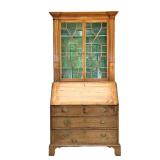 SLANT LID BOOKCASE | Pine slant lid bookcase with 2 glass paneled doors leading to a flip top secret