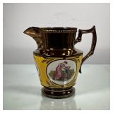 BRONZE PAINTED CERAMIC PITCHER | Ceramic pitcher painted metallic bronze with scene of mother playin