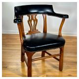 BLACK LEATHER LIBRARY ARMCHAIR | Curved back black leather armchair with studded border and carved w