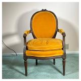 VINTAGE FRENCH STYLE ARMCHAIR | With orange/brown upholstery and cushion. Ornately carved wood. - l.