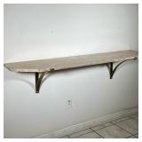 TRAVERTINE AND BRONZE WALL SHELF | Geometric stone shelf, having a polished travertine top and diago