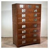 BAKER FURNITURE TALL CHEST | Tall dresser in dark wood with eleven drawers. Two-piece construction; 
