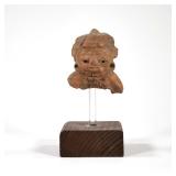 ANCIENT STATUE ON STAND | Fragment of an ancient clay statue mounted on an acrylic and wood stand. -