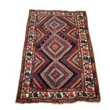 CAUCASIAN GEOMETRIC RUG | Having three central medallions within a cream border - l. 86 x w. 55 in.