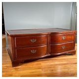 HUFFMAN-KOOS COFFEE TABLE | Wood coffee table with 4 paneled inlay over 4 drawers with brass pulls. 