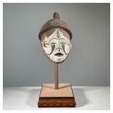 AFRICAN CARVED & PAINTED WOOD MASK | Nigerian 20th century carved wood mask mounted on wood plinth. 