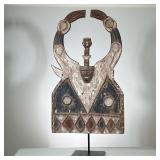 AFRICAN WOOD CARVING | Hand carved and painted African wood carving on black metal stand. - l. 22.5 