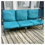 OUTDOOR 3 CUSHION COUCH | Slatted metal framed outdoor couch with wrought iron armrests and claw on 