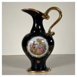 LIMOGES EWER | Decorated with a courting scene, with gilt highlights. - l. 5.5 x w. 4.25 x h. 9.25 i