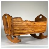 ANTIQUE WOODEN ROCKING CRIB | Small carved wooden crib with curved rocking legs. - l. 24.25 x w. 17 