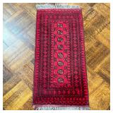 RED GEOMETRIC RUG | Having 8 small medallions with geometric border on red ground. - l. 54 x w. 22 i