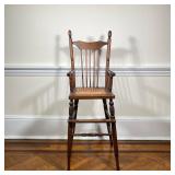 ANTIQUE HIGH CHAIR | With spindle carved back, arms, and legs. - l. 18 x w. 15 x h. 40 in 