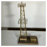 BRASS OIL WELL MODEL | A brass model of an oil well and shack mounted on an oak base. There are thre