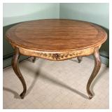 FRENCH COUNTRY PAINTED TABLE | A Round Table with a paneled light wood finish top with intentional a