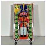 PEGGY KARR GLASS NUTCRACKER DISH | With label, “Peggy Karr Glass Handmade in the USA”. Nutcracker wi