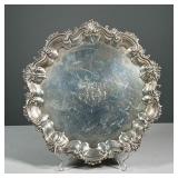 ANTIQUE HOWARD & CO. STERLING SILVER SALVER | With scrawl and acanthus leaf figured edge, raised on 