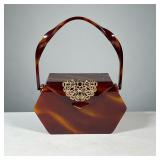 WILLARD’S LUCITE BAG | 1950s Bakelite style lucite handbag with interior mirror and decorative metal