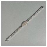 10K FILIGREE BRACELET | With central 0.10ct full-cut diamond flanked by two small mixed-cut emeralds