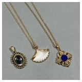 (3PC) PENDANT NECKLACES | Two gold-tone costume pendant necklaces, one by Avon with a lapis-style pe