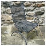 IRON SPRING BACK PATIO CHAIR | Having wrought iron arms and frame with rocking back from spring and 