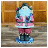 MONUMENTAL WOOD-CARVED SANTA SCULPTURE | Large carved wood and painted Santa figurine with checkered