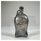 ENGRAVED SILVER OR SILVERPLATE FLASK | Shaped flask with scrolling acanthus decoration, monogrammed,