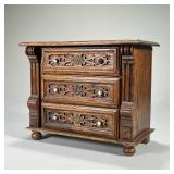 MINIATURE CHEST OF DRAWERS | Having three drawers with blind fretwork. - l. 12 x w. 6 x h. 10 in