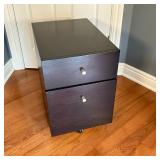 Filing Cabinet | Wood two drawer filing cabinet in black finish with castors. Top drawer and file bo