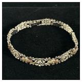 12K GOLD & STERLING BRACELET | Designed as a sterling silver bracelet with alternating links mountin