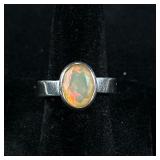 OPAL & STERLING RING | Designed as a sterling silver ring with oval mounted opal, size 6, marked “92