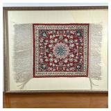 FRAMED MINIATURE RUG | Having central medallion with red backing a flower design. - l. 24 x w. 19 in