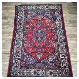 GEOMETRIC CAUCASIAN RUG | Having deep red backing with colorful central medallion and geometric bord
