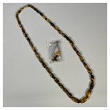 CARVED STONE COSTUME JEWELRY | Including carved stone necklace and pair of earrings.