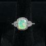 OPAL & STERLING RING | Designed as a sterling silver ring with large mounted opal bordered by melee 